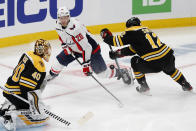 Boston Bruins' Craig Smith (12) defends against Washington Capitals' Lars Eller (20) during the first period of an NHL hockey game, Sunday, April 18, 2021, in Boston. (AP Photo/Michael Dwyer)