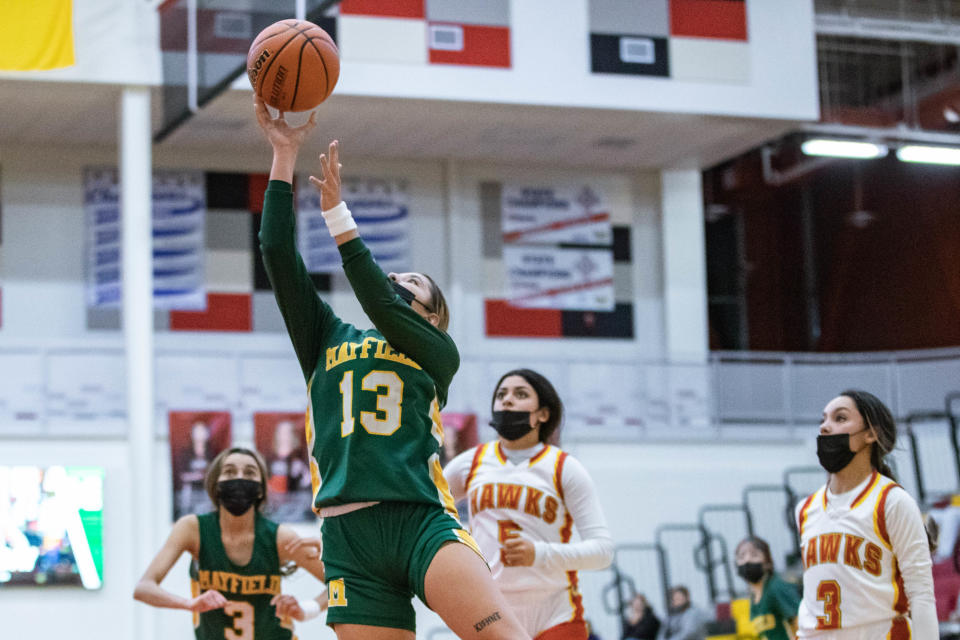 Jordyn Kiehne (13) goes up for a layup as the Mayfield Trojans face off against the Centennial Hawks at Centennial High School in Las Cruces on Tuesday, Jan. 11, 2022.