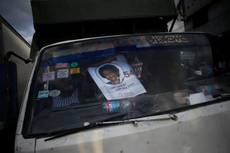 A woman holds a poster of presidential candidate Maryse Narcisse of Fanmi Lavalas party ahead of the presidential election, inside a truck in a street of Port-au-Prince, Haiti, November 17, 2016. REUTERS/Andres Martinez Casares