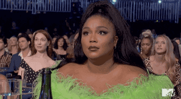 Lizzo shrugs during the MTV  Movie & TV Awards