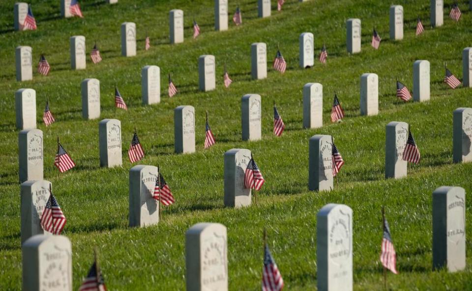 Flags are seen by military headstones at Los Angeles National Cemetery on Memorial Day in Los Angeles.