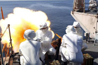 This handout photo provided by the Ministry of Defense shows crew members of the HMS Montrose firing a 41-round gun salute to to mark the death of the Duke of Edinburgh, in Duqm, Oman. Britain's Prince Philip, the irascible and tough-minded husband of Queen Elizabeth II who spent more than seven decades supporting his wife in a role that mostly defined his life, died on Friday. (Jay Allen/Ministry of Defense via AP)