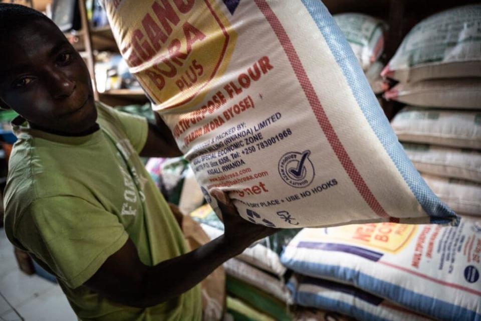 A man poses with a bag of wheat flour at a shop in Kigali, Rwanda, on March 23, 2022. (Photo by Simon WOHLFAHRT / AFP) (Photo by SIMON WOHLFAHRT/AFP via Getty Images)