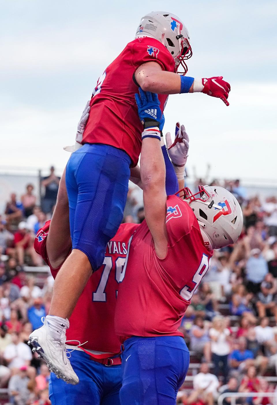 Roncalli Royals running back Luke Hansen (5) is lifted up by Roncalli Royals Luke Swartz (99) on Friday, Sept. 2, 2022, at Roncalli High School in Indianapolis. Roncalli Royals and the Bishop Chatard Trojans are tied at the half, 7-7. 