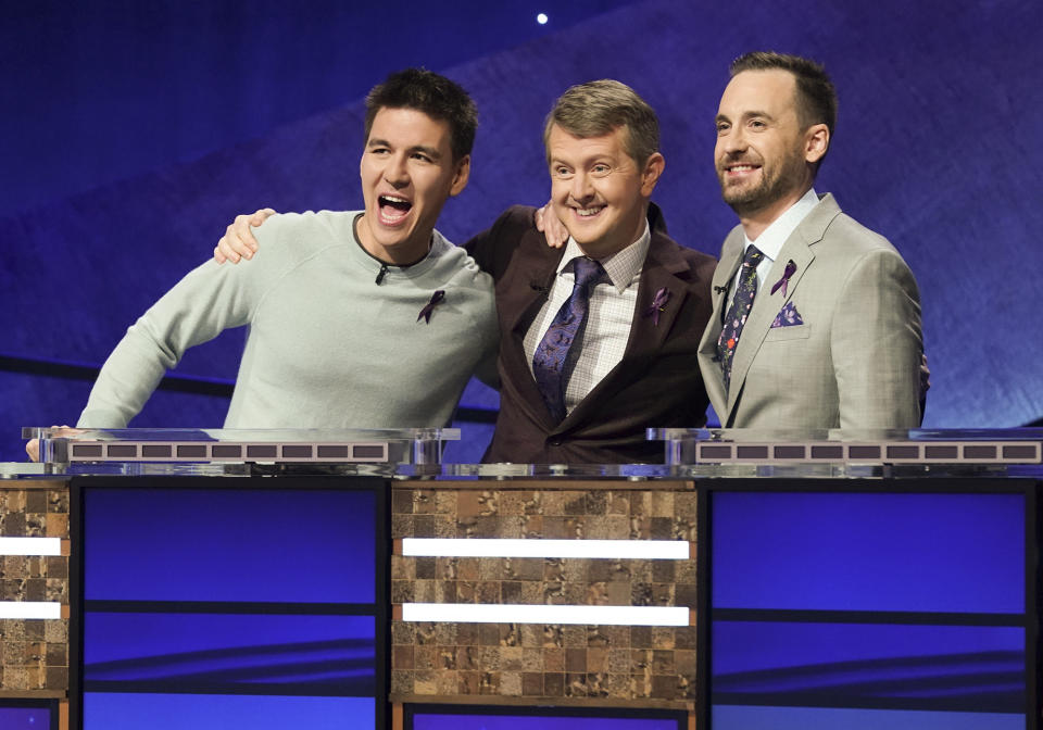 In this image released by ABC, contestants, from left, James Holzhauer, Ken Jennings and Brad Rutter appear on the set of "Jeopardy! The Greatest of All Time," in Los Angeles. The all-time top “Jeopardy!” money winners; Rutter, Jennings and Holzhauer, will compete in a rare prime-time edition of the TV quiz show which will air on consecutive nights beginning 8 p.m. EDT Tuesday. (Eric McCandless/ABC via AP)