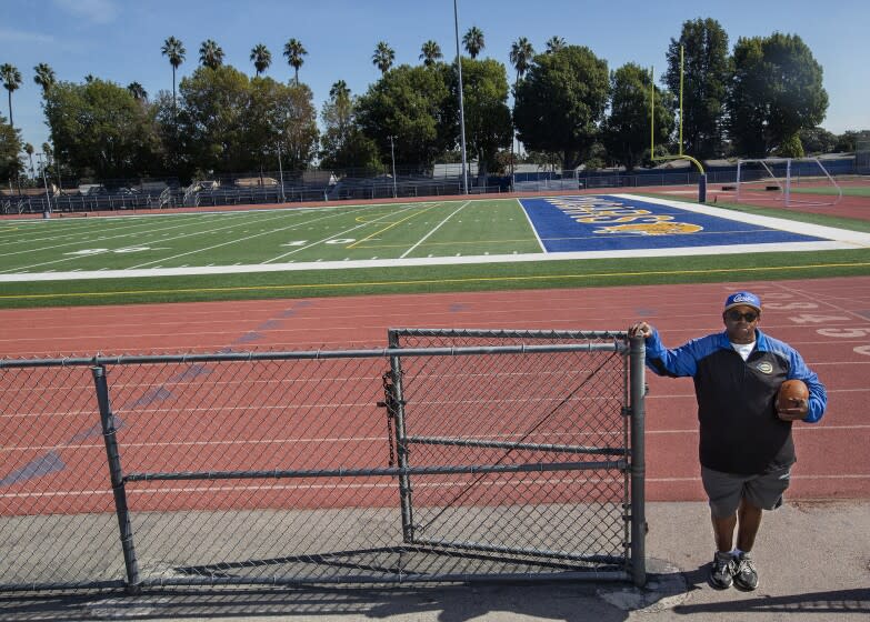 LOS ANGELES, CA - OCTOBER 20, 2021: Robert Garrett, head coach of the Crenshaw High School varsity football team, is photographed near the football field at the school. Crenshaw football team members have spent the week in quarantine, unable to practice, with this Friday's game against Locke High School looking unlikely. Last Friday, Crenshaw High School played a game against View Park Preparatory High School, a charter school authorized by L.A. Unified, that switched to remote learning for this week after enough students tested positive for the coronavirus to raise concerns. (Mel Melcon / Los Angeles Times)