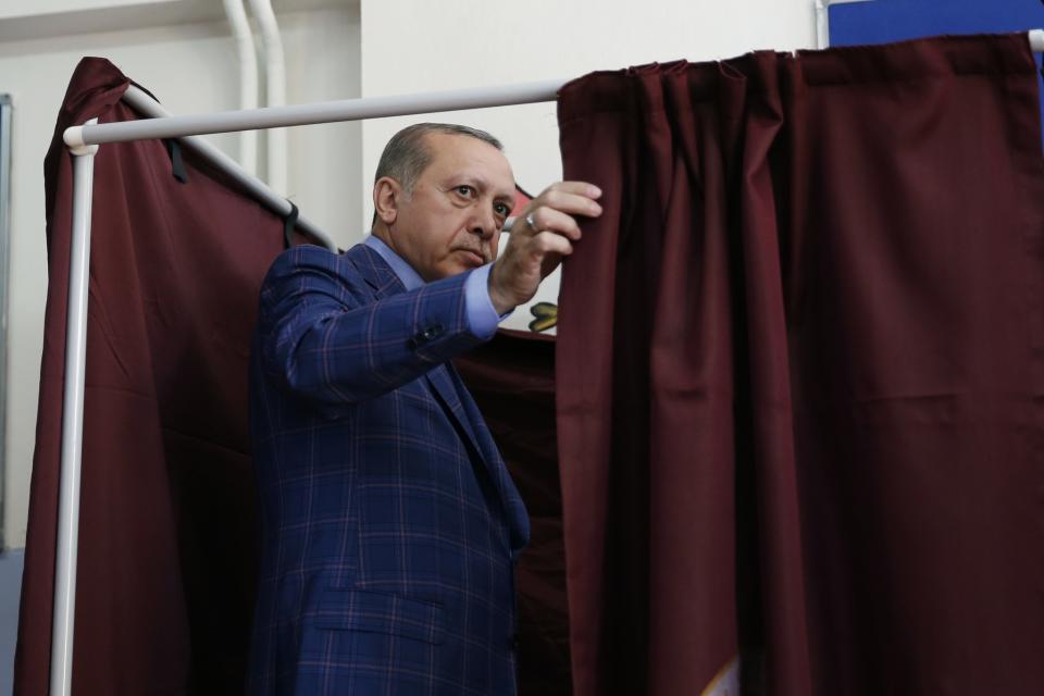 <p>Turkey’s President Recep Tayyip Erdogan enters a voting booth inside a polling station in Istanbul, Turkey, on Sunday, April 16, 2017. (AP Photo/Lefteris Pitarakis) </p>