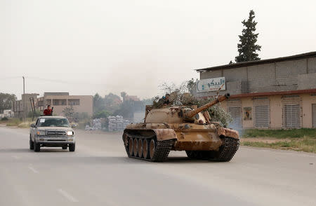 Members of Libyan internationally recognised government forces ride a tank taken over from Eastern forces, south western Tripoli, Libya April 23, 2019. REUTERS/Hani Amara