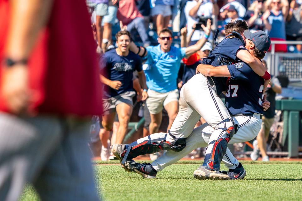 Ole Miss catcher Hayden Dunhurst (13) and pitcher Brandon Johnson (37) celebrate after getting the final out in a 4-2 win Sunday.