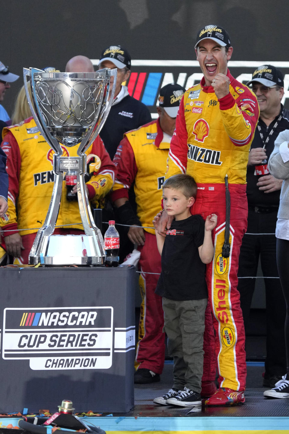 Joey Logano celebrates with his son Hudson after winning a NASCAR Cup Series auto race and championship Sunday, Nov. 6, 2022, in Avondale, Ariz. (AP Photo/Rick Scuteri)