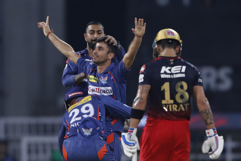 Lucknow Super Giants' Ravi Bishnoi celebrates the wicket of Royal Challengers Bangalore's Virat Kohli, right, with his teammates during the Indian Premier League (IPL) match between Lucknow Super Giants and Royal Challengers Bangalore in Lucknow, India, Monday, May 1, 2023. (AP Photo/Surjeet Yadav)