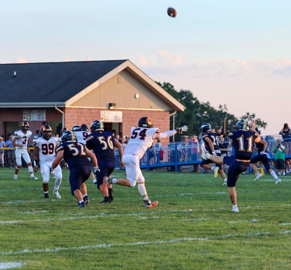 River Valley's Cayden Shidone punts the ball against Upper Sandusky in Week 1.