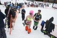 Claire McGuire (C) smiles after winning the women's snowboard division of the Bikini & Board Shorts Downhill at Crystal Mountain, a ski resort near Enumclaw, Washington April 19, 2014. Skiers and snowboarders competed for a chance to win one of four season's passes. REUTERS/David Ryder (UNITED STATES - Tags: SPORT SOCIETY)