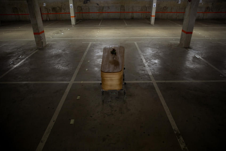 The coffin of the last COVID-19 victim sits at an underground parking garage that was turned into a morgue, at the Collserola funeral home in Barcelona, Spain, May 17, 2020. The funeral home closed a temporary morgue it had set up inside its parking garage to keep the victims of the Spanish city's coronavirus outbreak. The last coffin was removed and buried on Sunday. In 53 days of use, the temporary morgue has held more than 3,200 bodies. (AP Photo/Emilio Morenatti)