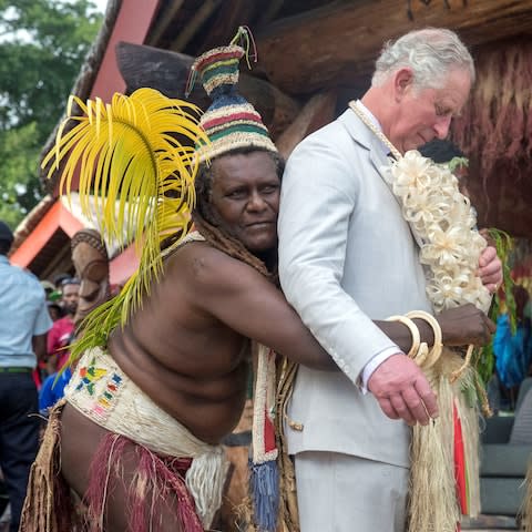 Prince Charles is given a grass skirt to wear prior to receiving a chiefly title during a visit to the Chiefs' nakamal, as he visits the South Pacific island of Vanuatu - Credit: Reuters
