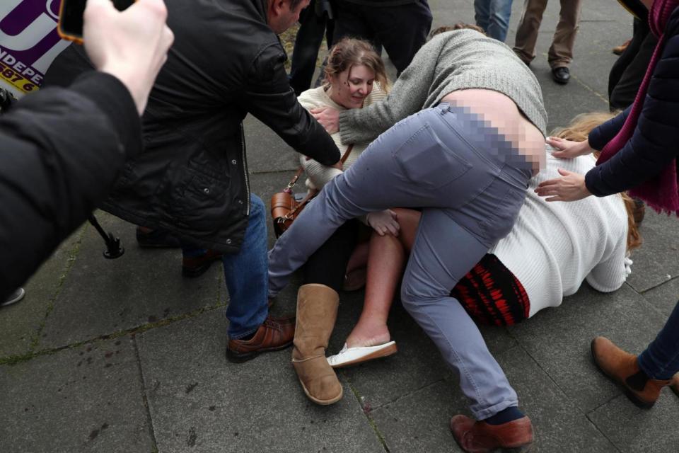 An onlooker wearing a grey jumper tries to break up an argument between two women at a Ukip rally in Hartlepool (Reuters)