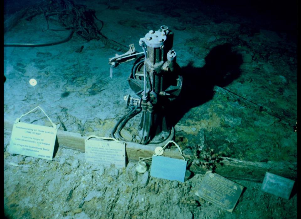 Plaques left behind by visiting expeditions, seen in this July 2003 photo, are positioned near the telemotor on the deck of the Titanic more than two miles underwater in the north Atlantic. 