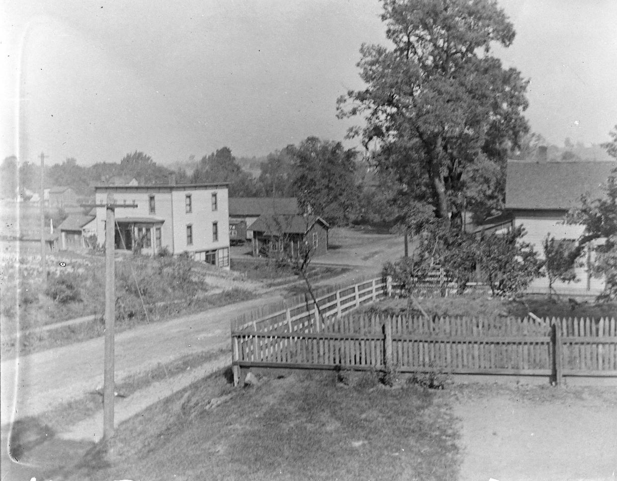 The Munroe Falls Historical Society helped identify this photo from the early 20th century. This view is looking north on North Main Street (Route 91) near Munroe Falls Avenue. The building at the top left still stands near the railroad tracks. It's the Scissor Room at 21 N. Main St.