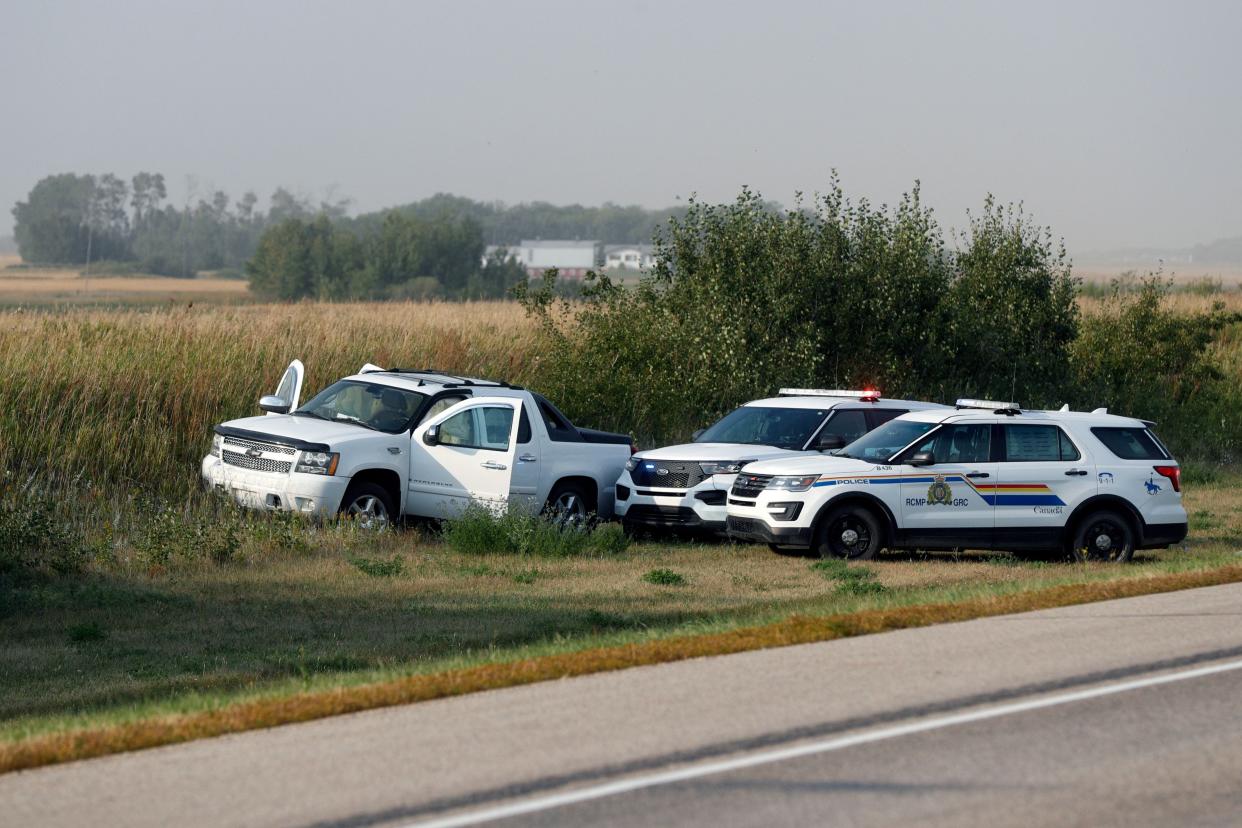 Royal Canadian Mounted Police vehicles are seen next to a pickup truck at the scene where suspect Myles Sanderson was arrested, along Highway 11 in Weldon, Saskatchewan, Canada, on September 7, 2022. - Canadian police said September 7, 2022 they arrested the second and final suspect over the stabbing spree that left 10 people dead and 18 wounded in a remote Indigenous community, two days after the first suspect was found dead. (Photo by LARS HAGBERG / AFP) (Photo by LARS HAGBERG/AFP via Getty Images) ORIG FILE ID: AFP_32HW42J.jpg