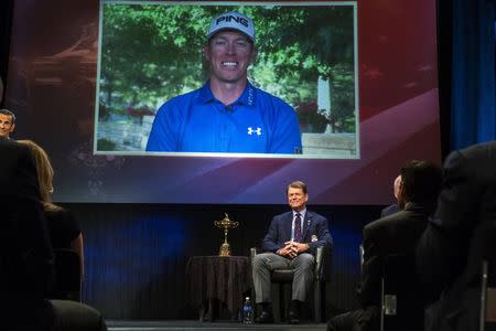Ryder Cup team U.S. captain Tom Watson smiles as he announces that Hunter Mahan (on screen) will be one of his three picks to add to this year's Ryder Cup squad during an event in New York September 2, 2014.REUTERS/Lucas Jackson