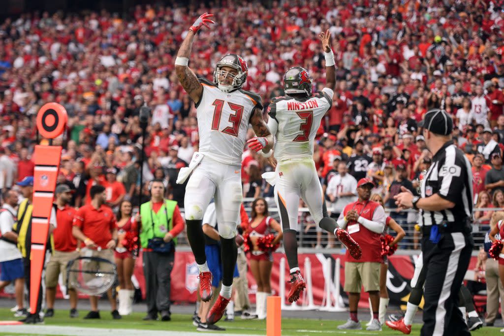 Sep 18, 2016; Glendale, AZ, USA; Tampa Bay Buccaneers wide receiver Mike Evans (13) and quarterback Jameis Winston (3) celebrate a touchdown against the Arizona Cardinals during the second half at University of Phoenix Stadium. The Cardinals won 40-7. Mandatory Credit: Joe Camporeale-USA TODAY Sports