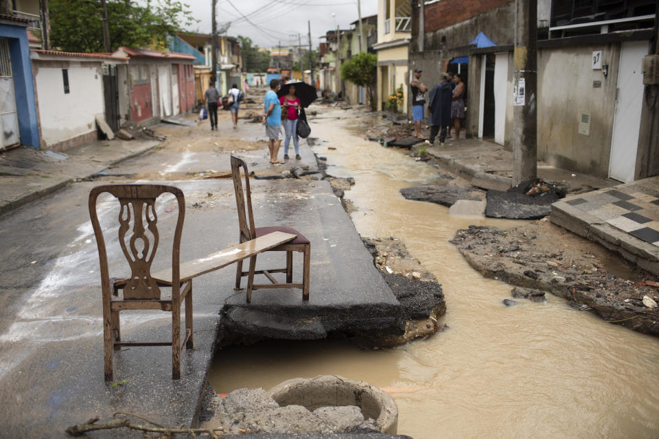 A couple of chairs lay on a flood damaged street after heavy rains caused flash floods in the Realengo neighborhood of Rio de Janeiro, Brazil, Monday, March 2, 2020. The water flooded the streets and entered homes of residents, with at least 4 deaths reported. (AP Photo/Silvia Izquierdo)
