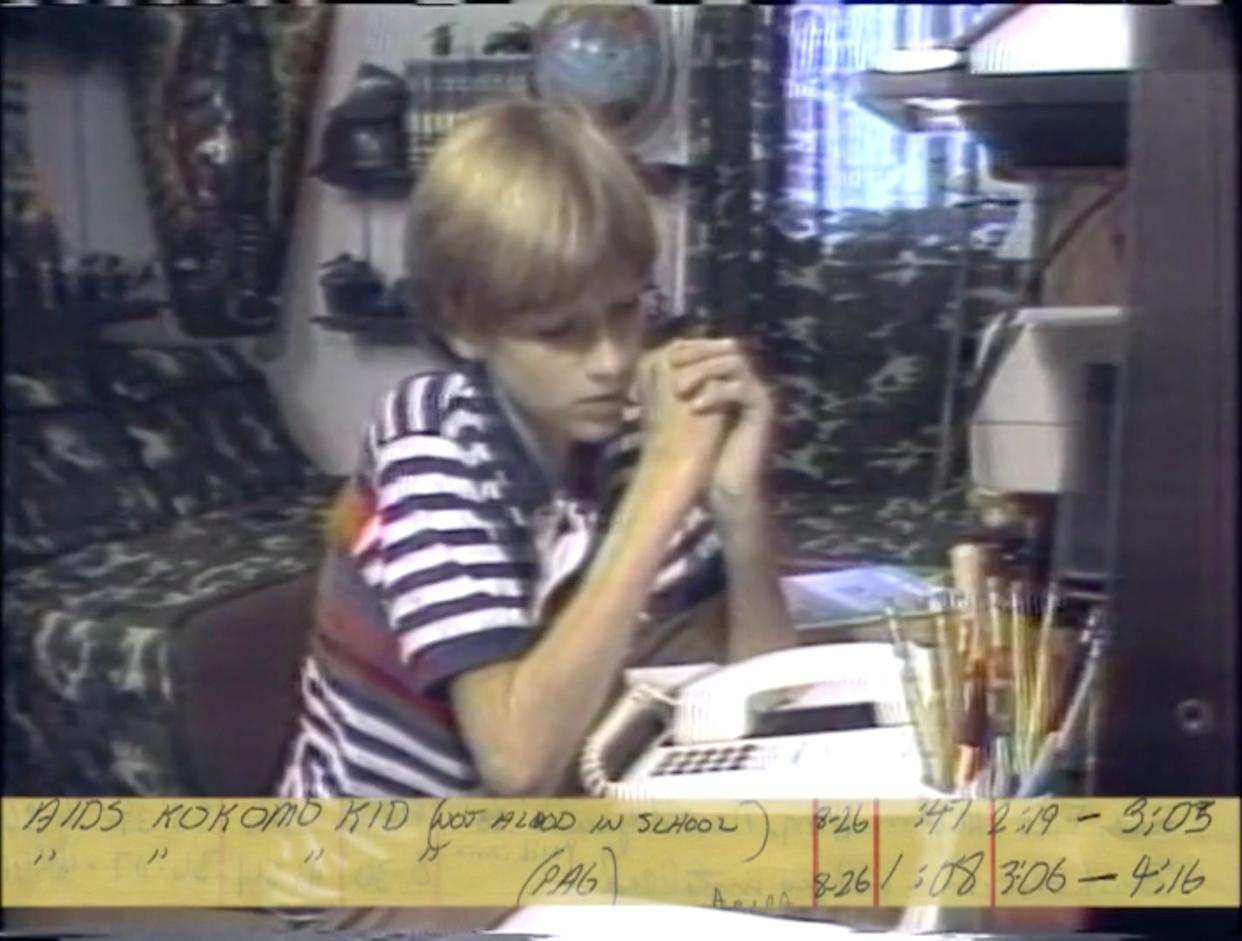 Captured on a WSJV-TV news tape, Ryan White struggles to hear his teacher on the phone as he remote learns from home in the 1980s. He was not allowed in his school because he had AIDS. White would have turned 50 on Dec. 6, 2021.