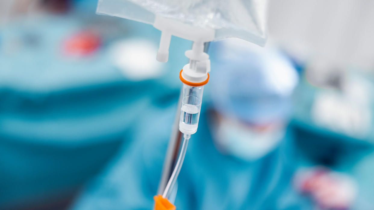  Close-up of IV drip bag in emergency room. Medicine is passing through pipe from intravenous drip. 