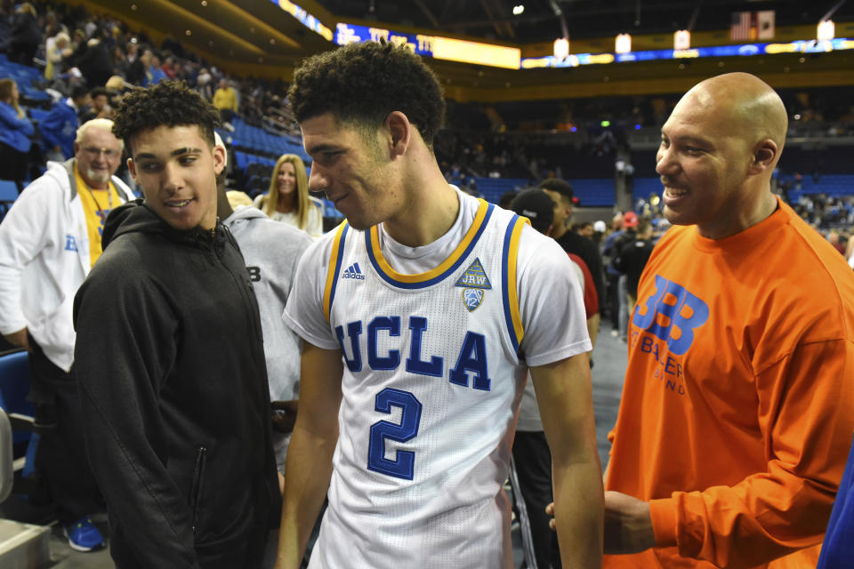 Lonzo (C), LiAngelo (L), LaVar Ball and the whole Ball family are coming to your Facebook page. Batten down the hatches. (AP)