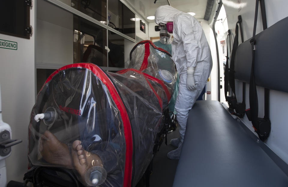 Paramedics in hazmat suits move a COVID-19 patient inside a biocontainment unit from his home to a hospital in the Iztapalapa district of Mexico City, Tuesday, Feb. 2, 2021. (AP Photo/Marco Ugarte)