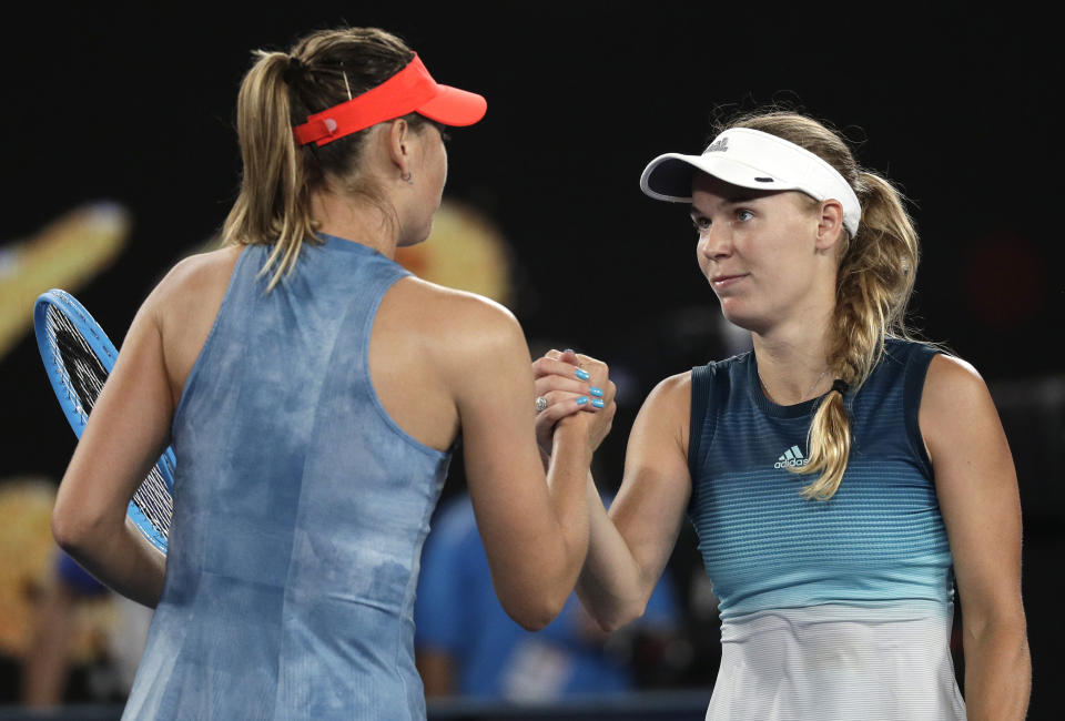 Russia's Maria Sharapova, left, is congratulated by Denmark's Caroline Wozniacki after winning their third round match at the Australian Open tennis championships in Melbourne, Australia, Friday, Jan. 18, 2019. (AP Photo/Kin Cheung)