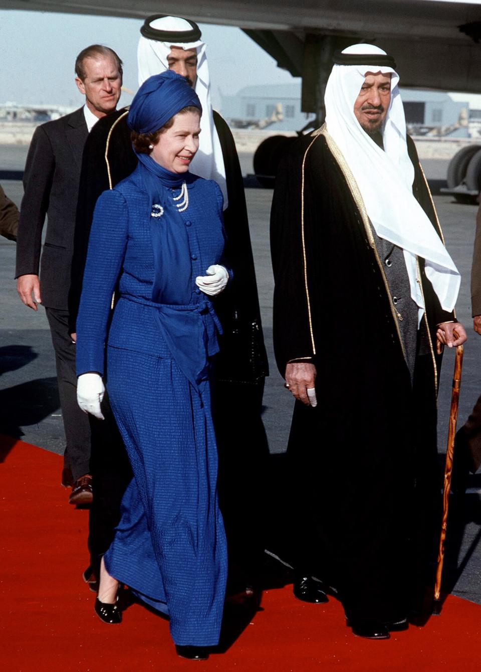 Queen Being Greeted By King Khalid Ibn Abdul Aziz Al Saud On Arrival By Concorde At Riyadh Airport In Saudi Arabia. She Wears A Long Day Dress And Covers Her Hair To Respect The Customs Of Her Hosts. (day Date Not Certain. Gulf Tour Dates 12 Feb - 1 March 1979)