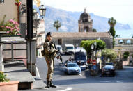 A military guard stands watch at the G7 summit in Taormina, Italy, May 26, 2017. REUTERS Dylan Martinez