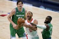 Houston Rockets guard Eric Gordon (10) is defended by Dallas Mavericks' Boban Marjanovic (51) and Tim Hardaway Jr. (11) during the second half of an NBA basketball game in Dallas, Saturday, Jan. 23, 2021. (AP Photo/Tony Gutierrez)