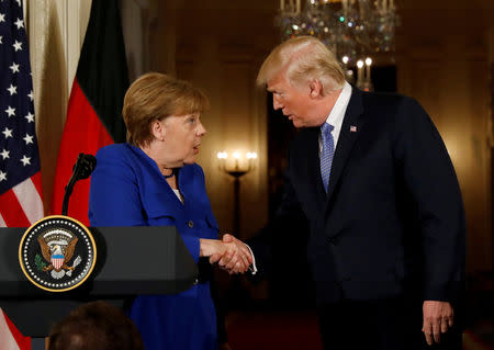 FILE PHOTO: U.S. President Donald Trump greets Germany's Chancellor Angela Merkel during a joint news conference in the East Room of the White House in Washington, U.S., April 27, 2018. REUTERS/Kevin Lamarque/File Photo