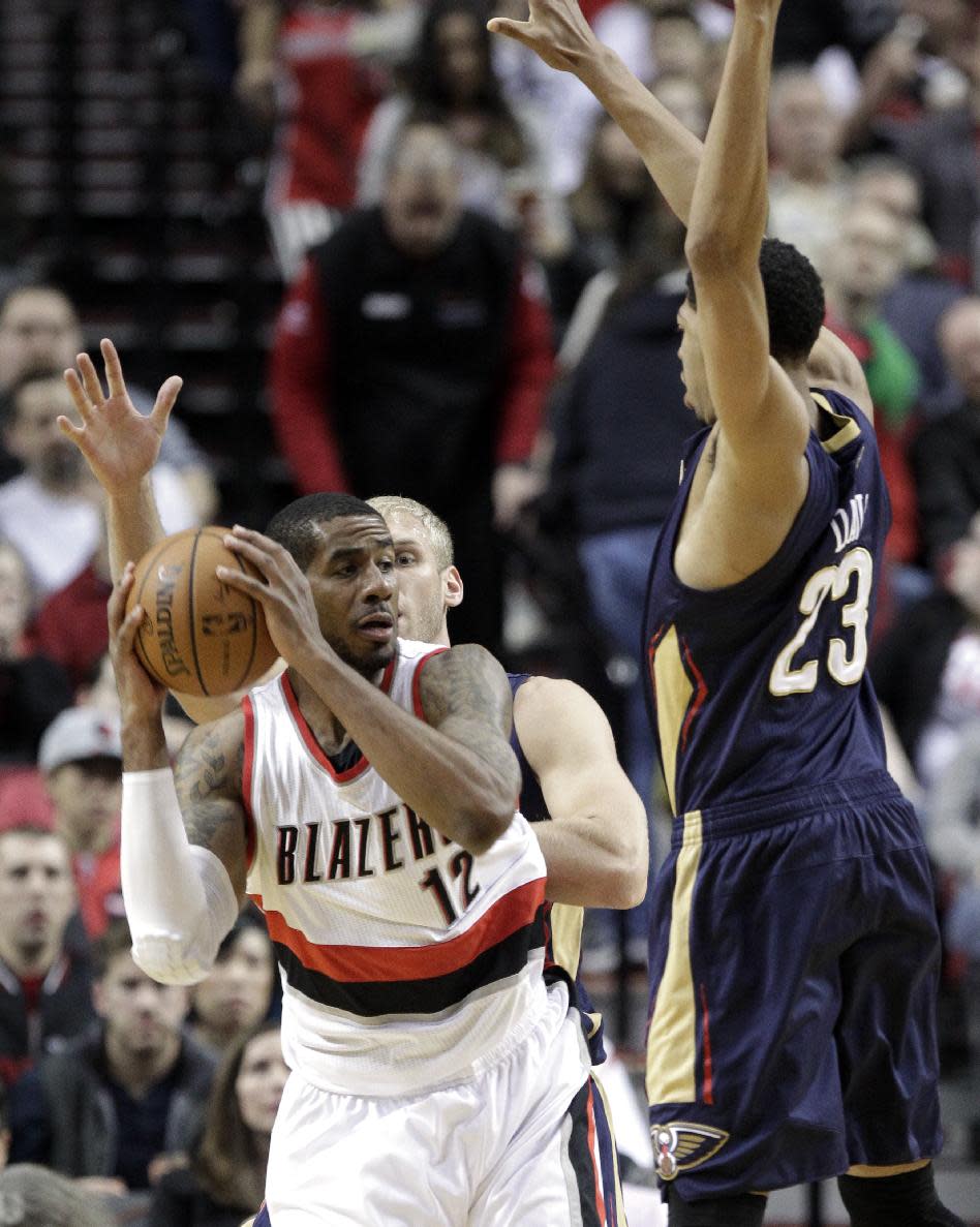 Portland Trail Blazers forward LaMarcus Aldridge, left, is double-teamed by New Orleans Pelicans forward Anthony Davis, right, and Greg Stiemsma during the first half of an NBA basketball game in Portland, Ore., Sunday, April 6, 2014. (AP Photo/Don Ryan)