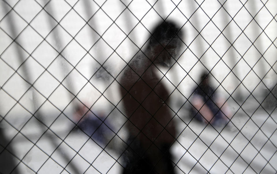 FILE - In this May 26, 2010, file photo, men sit in the sun in the health ward at the Otay Mesa immigration detention center in San Diego. Thousands of immigration detainees have been moved around the country, far from their homes, for reasons like bed availability or medical care, according to federal officials. San Diego County has approved a plan to provide attorneys to immigrants facing deportation proceedings. The Board of Supervisors on Tuesday, May 4, 2021, approved a $5 million, one-year pilot program. It would provide lawyers for free to those detained at Otay Mesa Detention Center, the local federal immigration detention facility. San Diego will be the first southern border county in the U.S. to provide such legal representation. (AP Photo/Gregory Bull, File)