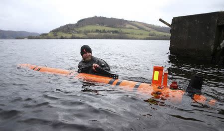 Subsea engineer John Haig launches Munin, an intelligent marine robot, to explore Loch Ness in Scotland, Britain April 13, 2016. REUTERS/Russell Cheyne