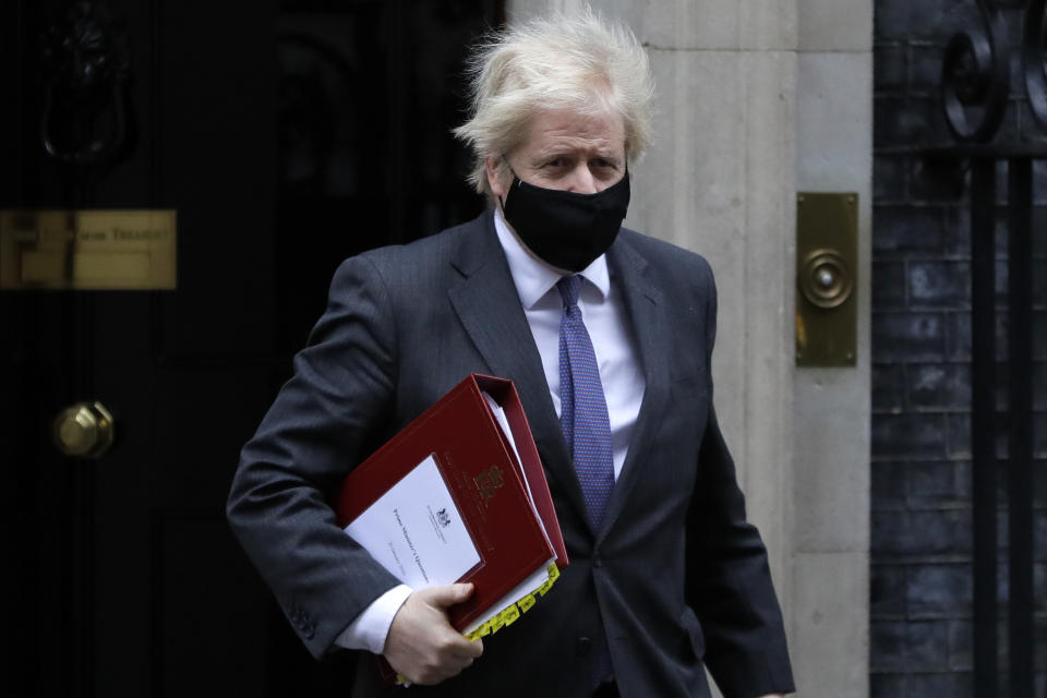 Britain's Prime Minister Boris Johnson leaves Downing Street to attend the weekly session of PMQs in parliament in London, Wednesday, Jan. 20, 2021. (AP Photo/Kirsty Wigglesworth)