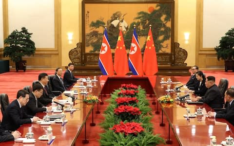 Chinese President Xi Jinping, fourth from left, and North Korean leader Kim Jong Un, second from right, meet at the Great Hall of the People in Beijing - Credit: AP