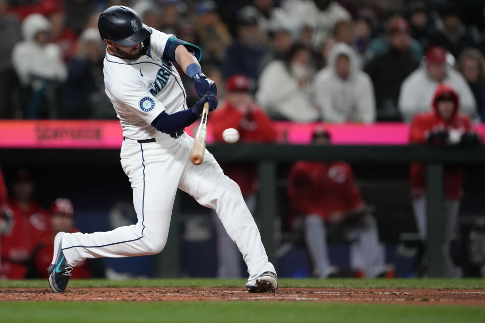 Seattle Mariners' Mitch Haniger hits an RBI single against the Cincinnati Reds during the sixth inning of a baseball game Tuesday, April 16, 2024, in Seattle. (AP Photo/Lindsey Wasson)