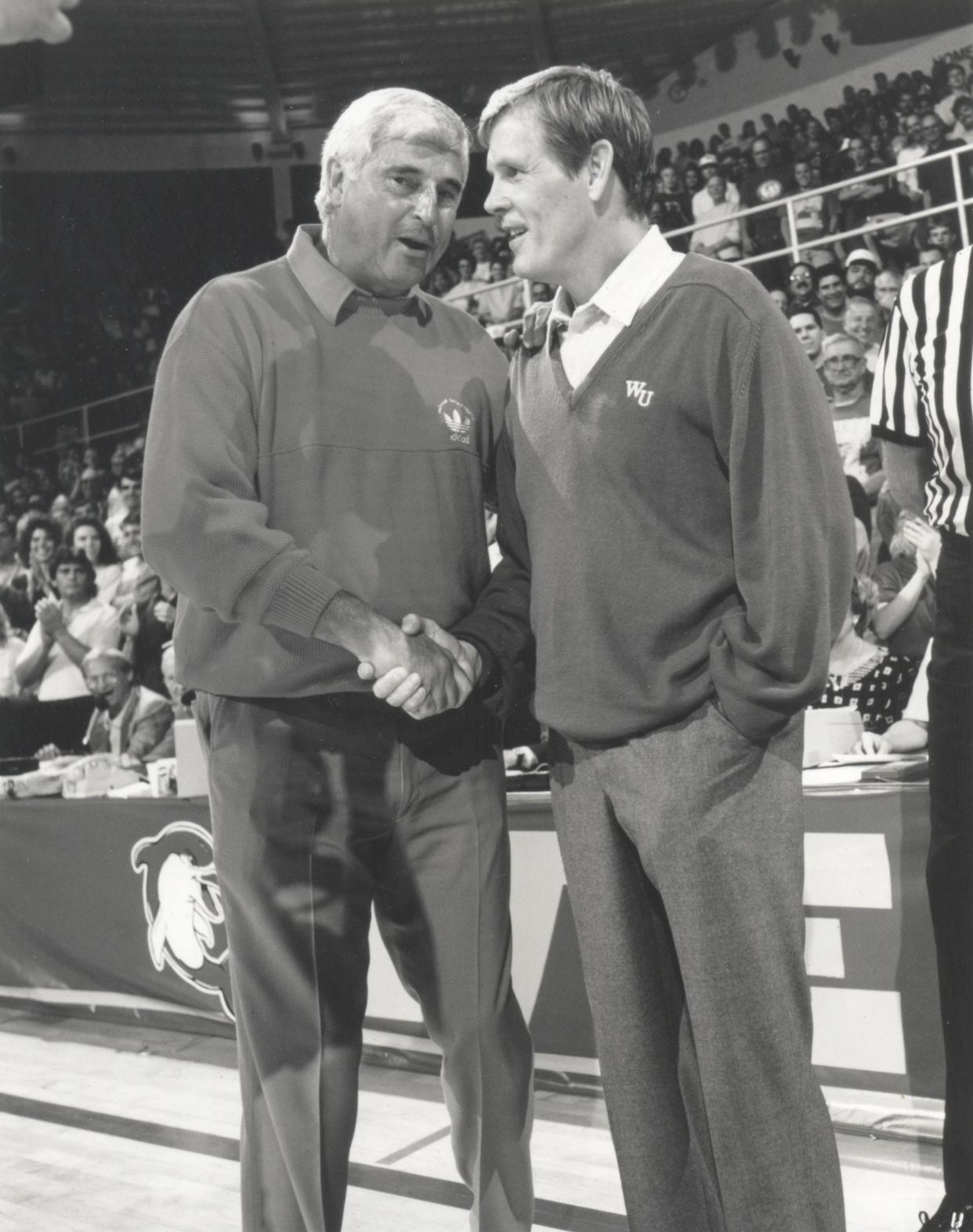 Competing coaches Pete Bell (Nick Nolte, right) and Bobby Knight (himself) shake hands in 