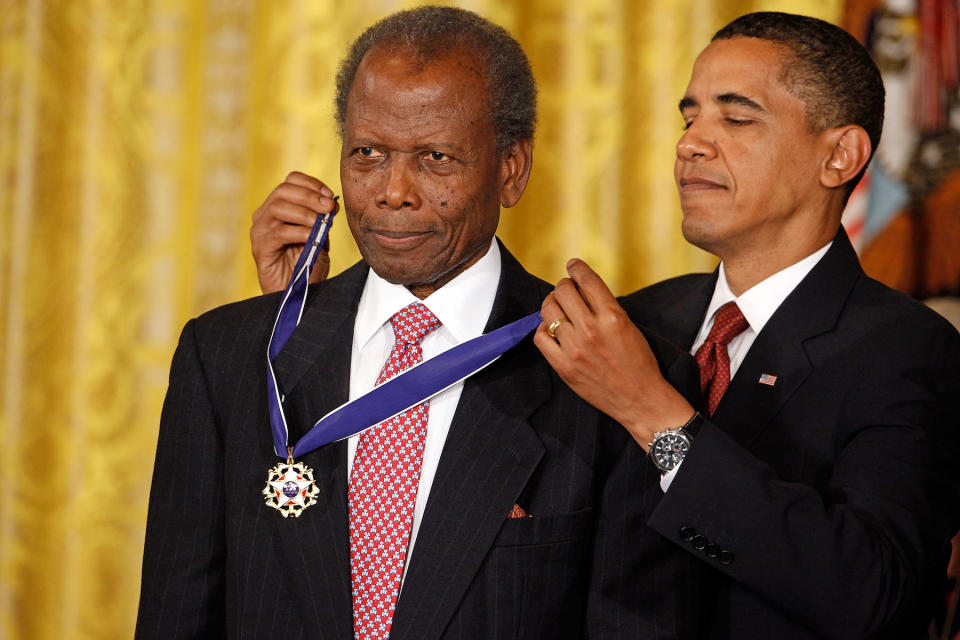President Barack Obama presents the Medal of Freedom to Academy Award-winning actor Sidney Poitier during a ceremony in the East Room of the White House August 12, 2009, in Washington, DC. 