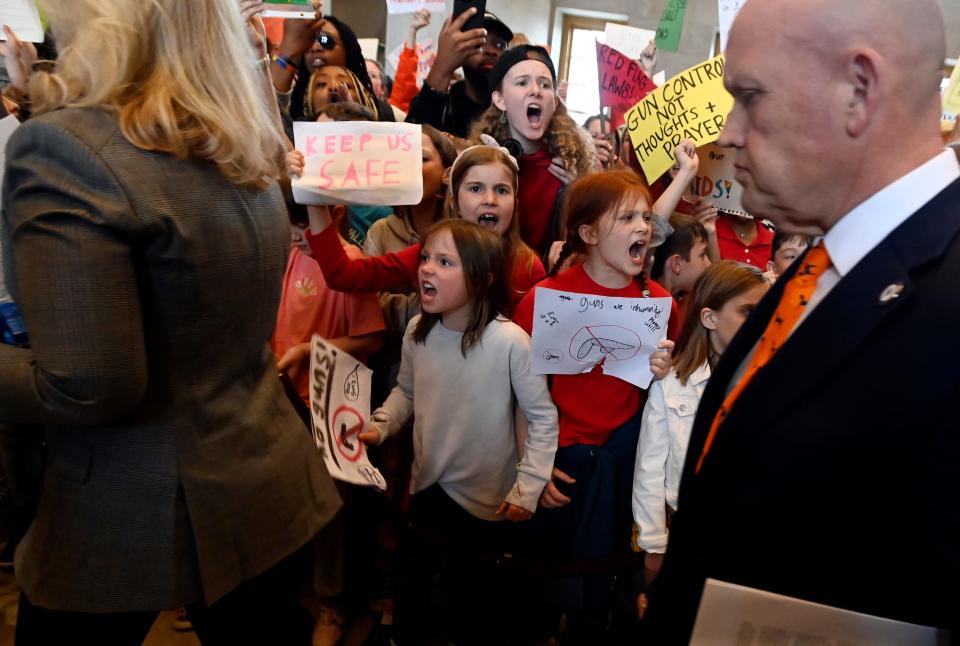 Eakin Elementary students Eleanor Parker, 9, white top, and Caia Cascio-Tesdahl, 8, next to Parker, shout at state lawmakers inside the state capitol as they demonstrate against gun violence and call for gun law reform during The March For Our Lives walkout Monday, April 3, 2023, in Nashville, Tenn. The group is demanding tougher gun control laws on the one-week anniversary of the mass shooting at Covenant School during which three students and three adults were killed.