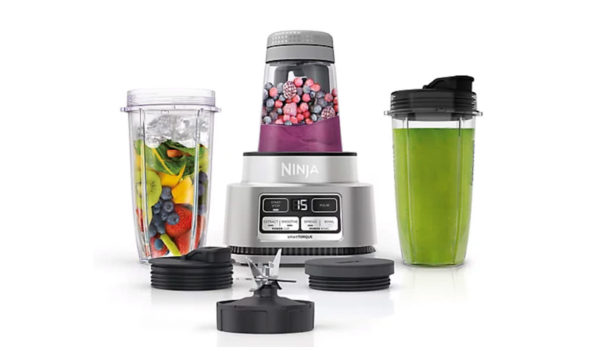 Ninja with 3 smoothie cups at different stages of prep 