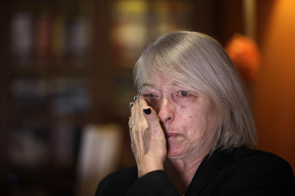 In this picture taken on Friday, Jan. 31, 2020 Yolanda Martinez Garcia cries during an interview with the Associated Press at her home, in Milan, Italy.Her son was sexually abused by one of the priests of the Legion of Christ, a disgraced religious order. (AP Photo/Luca Bruno)