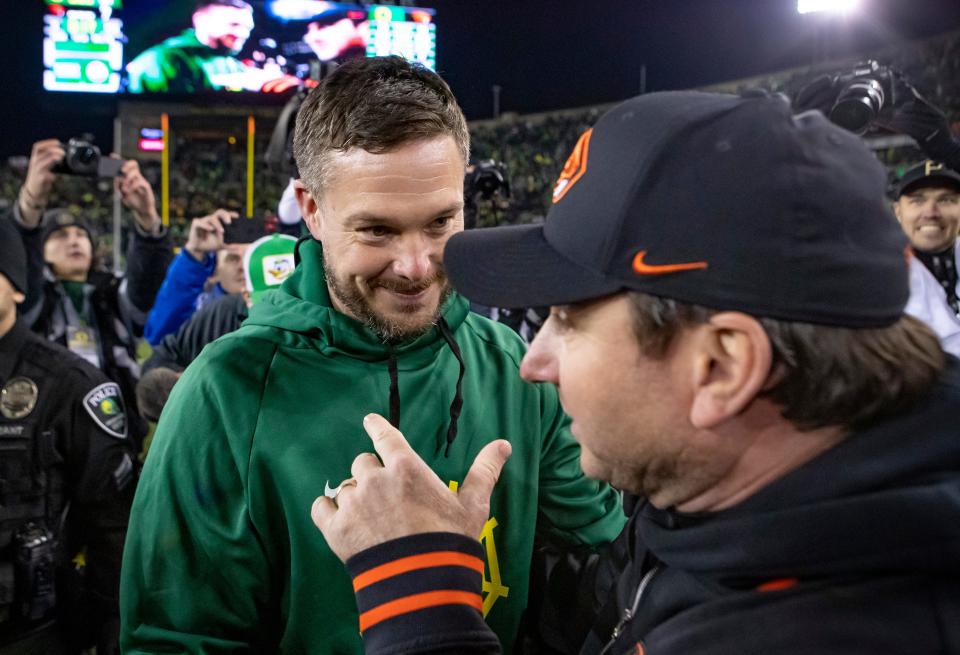 Oregon head coach Dan Lanning talks with Oregon State head coach Jonathan Smith as the No. 6 Oregon Ducks take on the No. 16 Oregon State Beavers Friday, Nov. 24, 2023, at Autzen Stadium in Eugene, Ore.