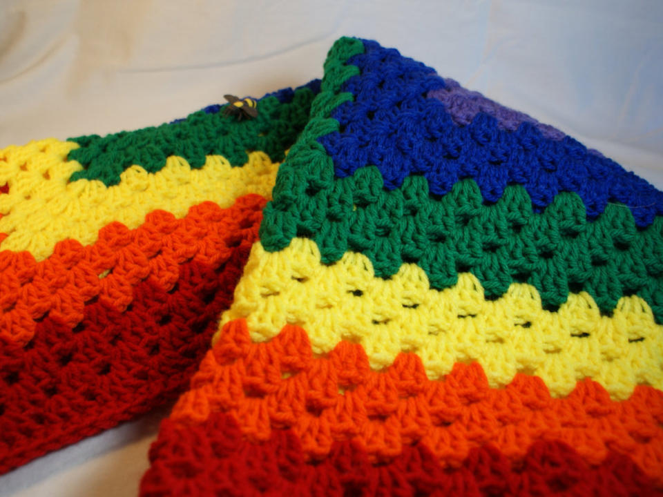 $35, <a href="https://www.etsy.com/listing/459222650/rainbow-baby-blanket-crocheted-receiving" target="_blank">QueenBsBusyWork</a>