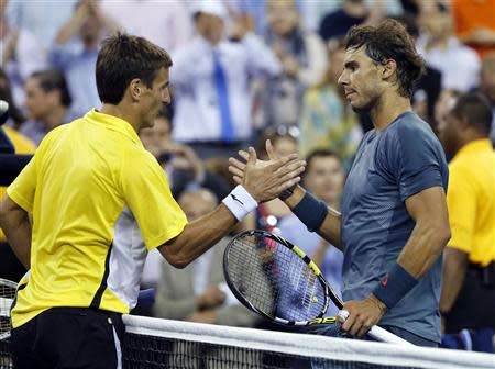 Rafael Nadal of Spain shakes hands after defeating compatriot Tommy Robredo after their men's quarter-final match at the U.S. Open tennis championships in New York September 4, 2013. REUTERS/Ray Stubblebine