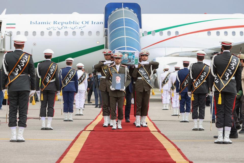 Soldiers carry the coffin of the late Iranian President Ebrahim Raisi at Mehrabad Airport in Tehran (via REUTERS)